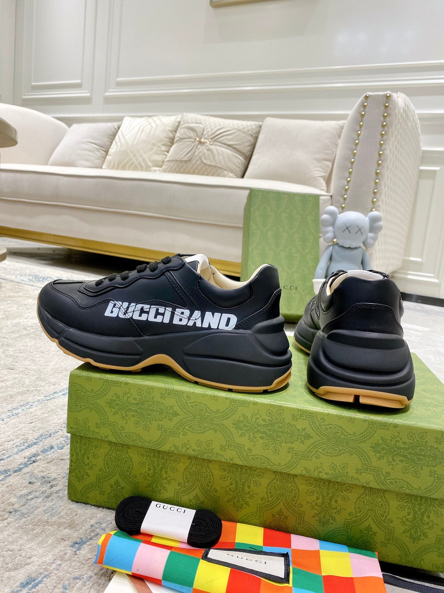 Gucci unisex sneakers, black pair with rear view on green shoebox