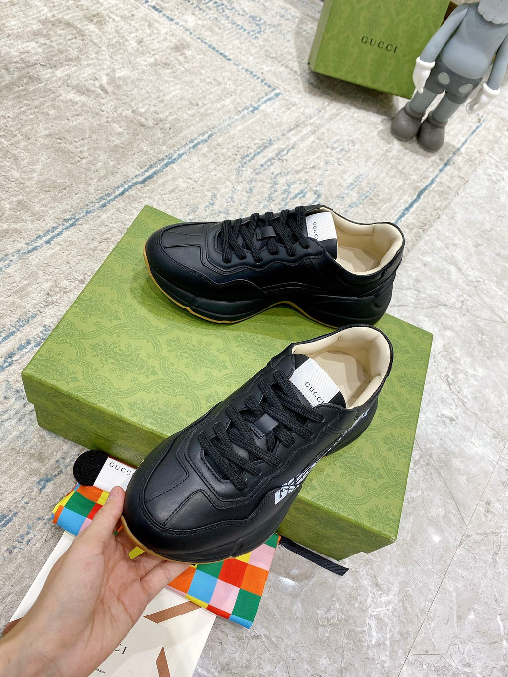 Gucci unisex sneakers, black leather sneakers with beige insoles, lace-up close-up