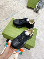 Gucci unisex sneakers, black leather sneakers with beige insoles, lace-up close-up