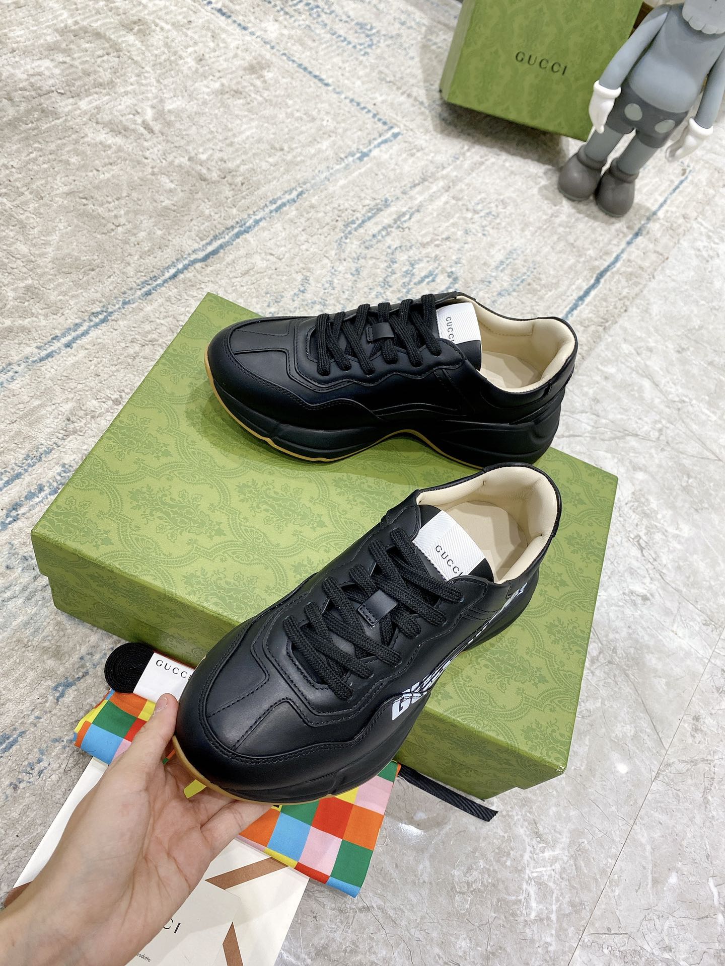 Gucci unisex sneakers, black leather sneakers with beige insoles, lace-up close-up