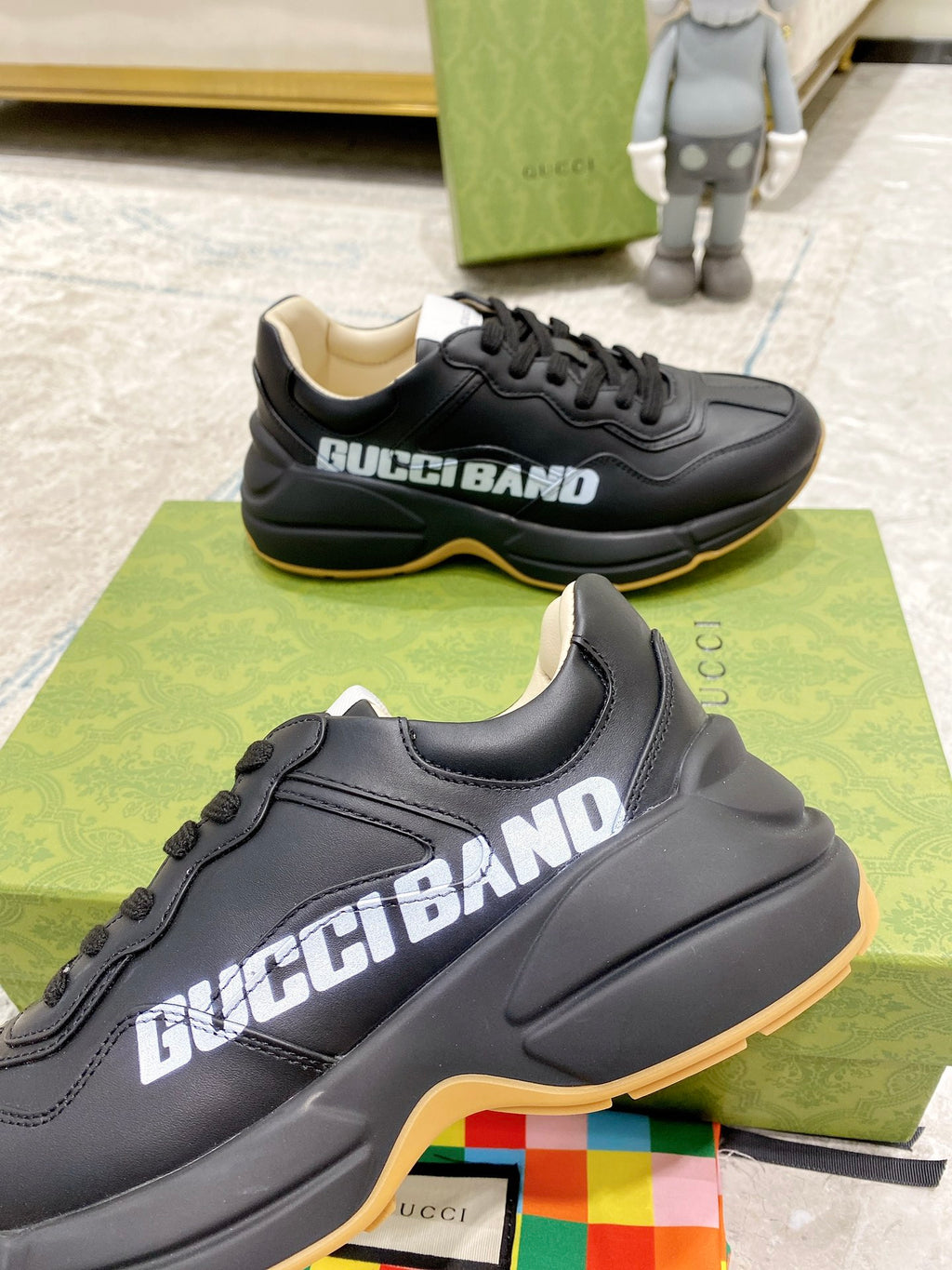 Gucci unisex sneakers, black upper close-up with GucciBand logo and gum trim