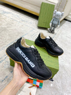 Gucci unisex sneakers, black side view with gum outsole trim and lace-up