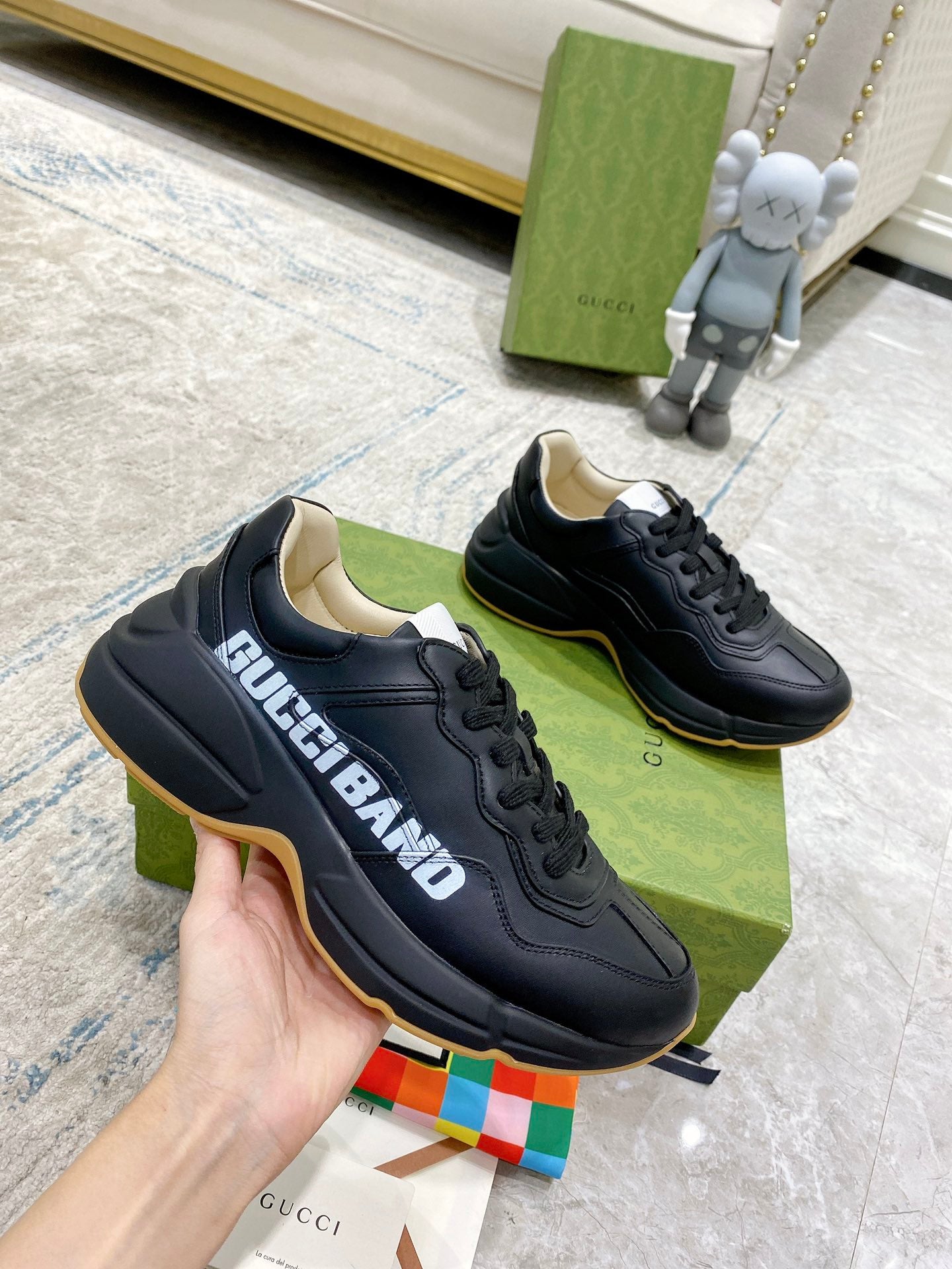Gucci unisex sneakers, black side view with gum outsole trim and lace-up