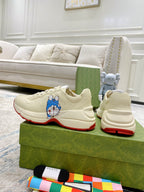 Gucci unisex sneakers pair, white leather with Doraemon patch and red outsole