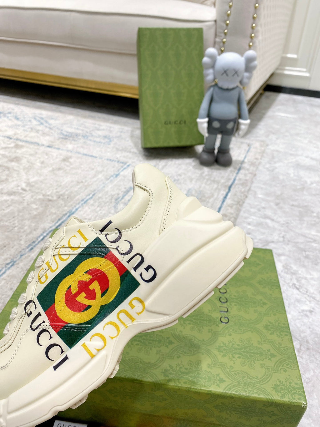 Gucci unisex white sneakers with large GG emblem stripe and lace-up vamp.