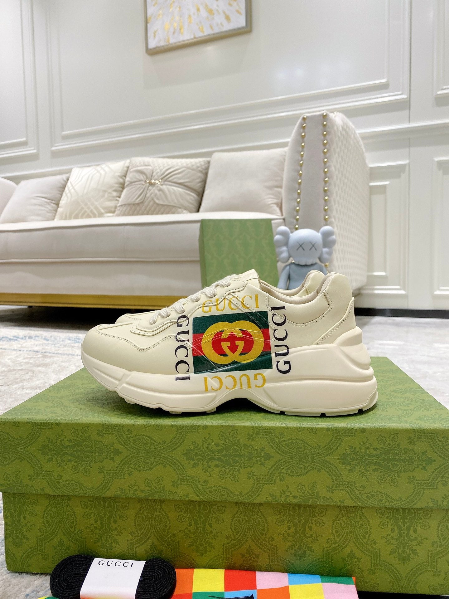 Gucci unisex white sneakers with GG stripe detail on the side and textured sole.