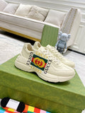 Gucci unisex leather sneakers, white with lace-up design and GG logo detail.