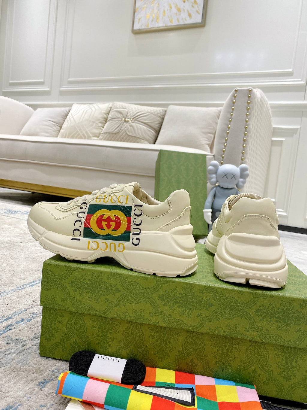 Gucci unisex white sneakers, lace-up style with GG stripe detail and cushioned sole.