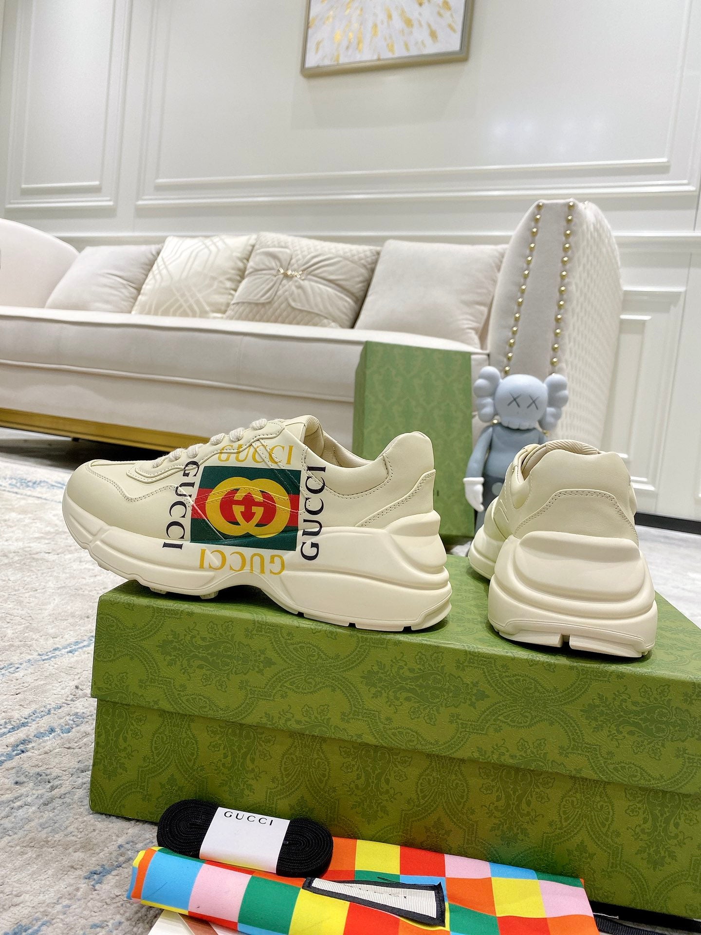 Gucci unisex white sneakers, lace-up style with GG stripe detail and cushioned sole.