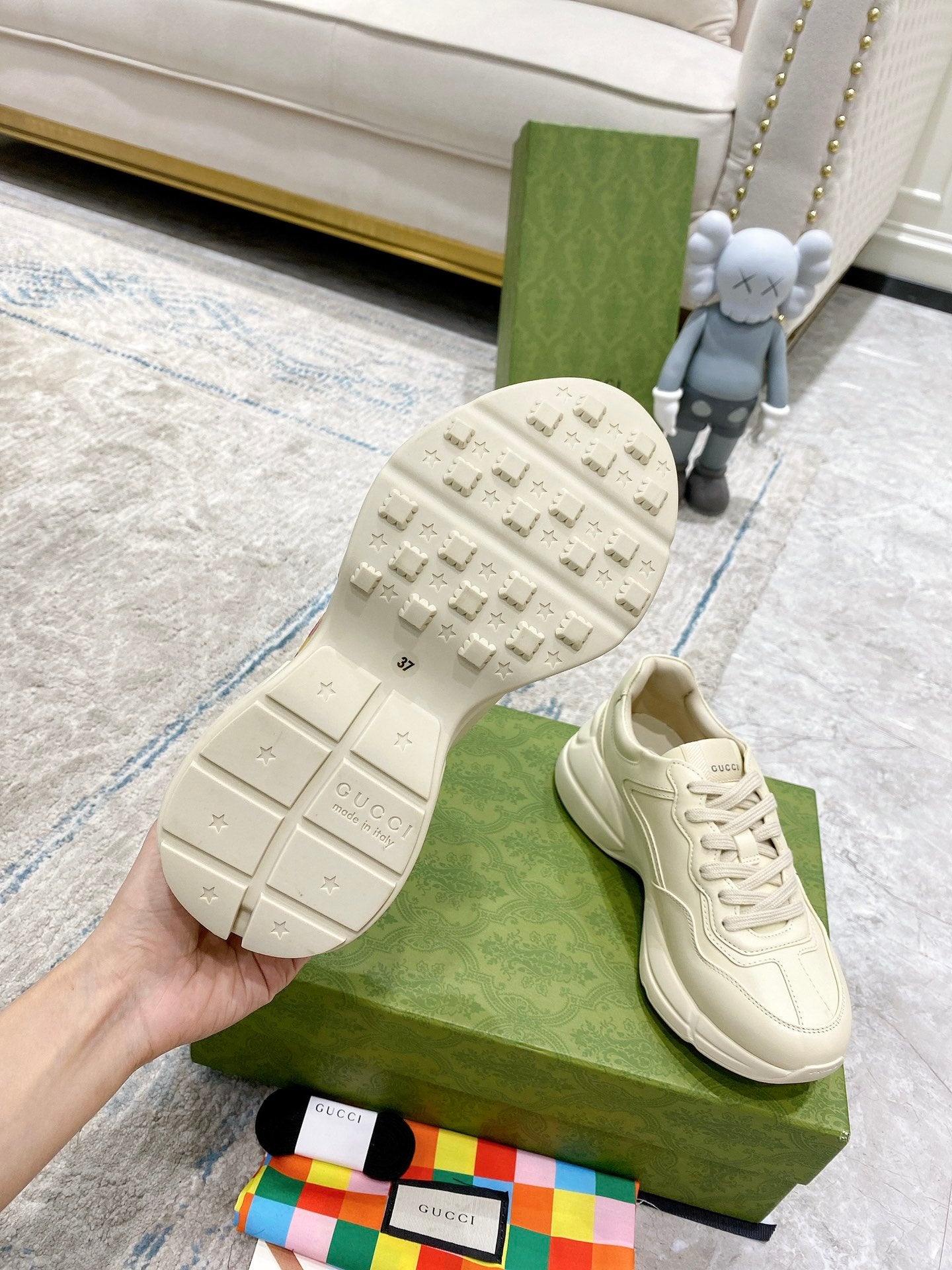 Gucci unisex white sneakers with treaded rubber sole and lace-up upper.