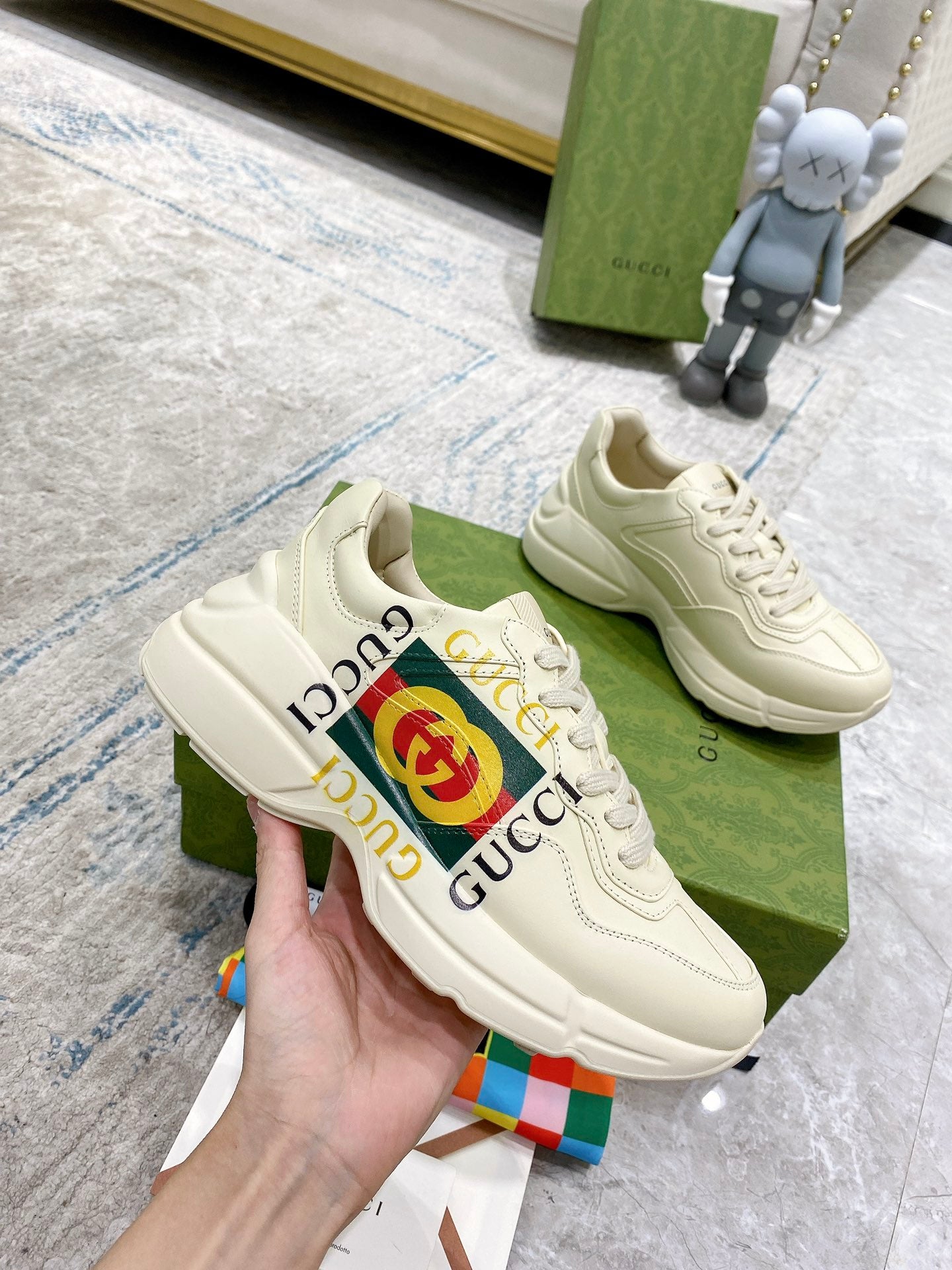 Gucci unisex white low-top sneakers with GG logo stripe and lace-up front.