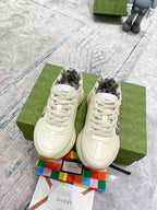 Gucci unisex sneakers pair, cream lace-up fronts with blue patterned lining