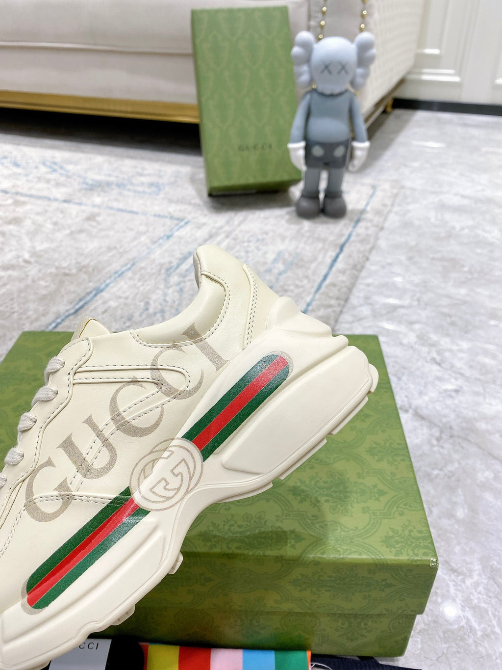 Cream Gucci sneakers close-up, side stripe detail and lace-up upper