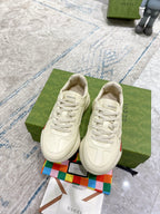 Cream leather lace-up Gucci sneakers, side view with green red web stripe detail