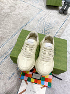 Gucci unisex sneakers in cream, lace-up with embossed 1921 and GUCCI stripe on sides