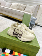 Gucci unisex sneakers, cream with bold GUCCI 1921 graphic on side and thick rubber sole