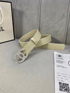 Beige leather belt with Chanel CC rhinestone buckle beside a Chanel document card