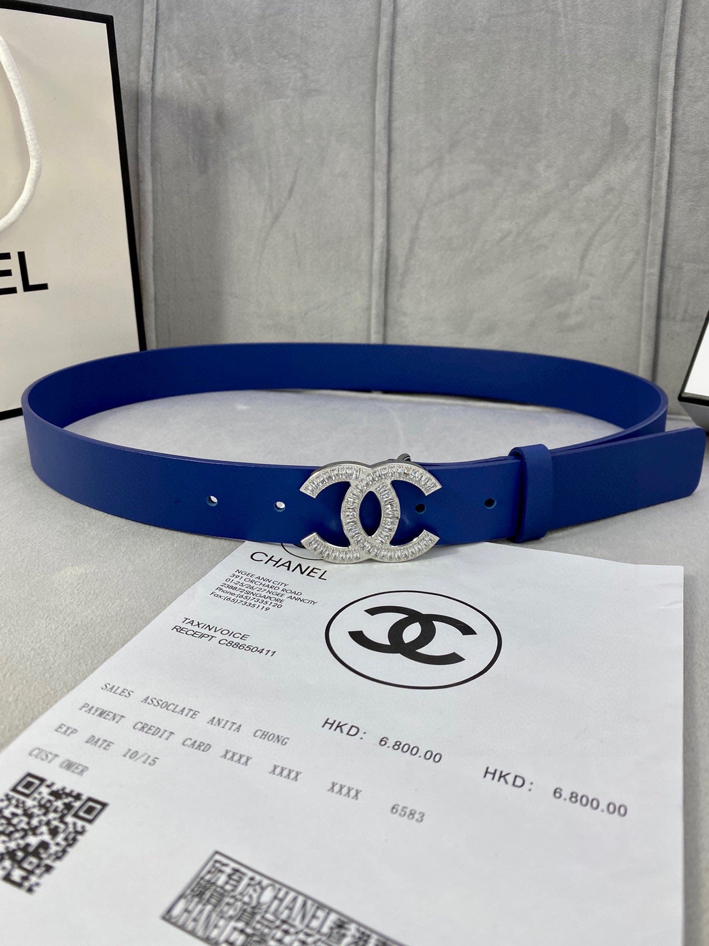 Blue leather belt with silver-tone rhinestone CC buckle and round hole detailing
