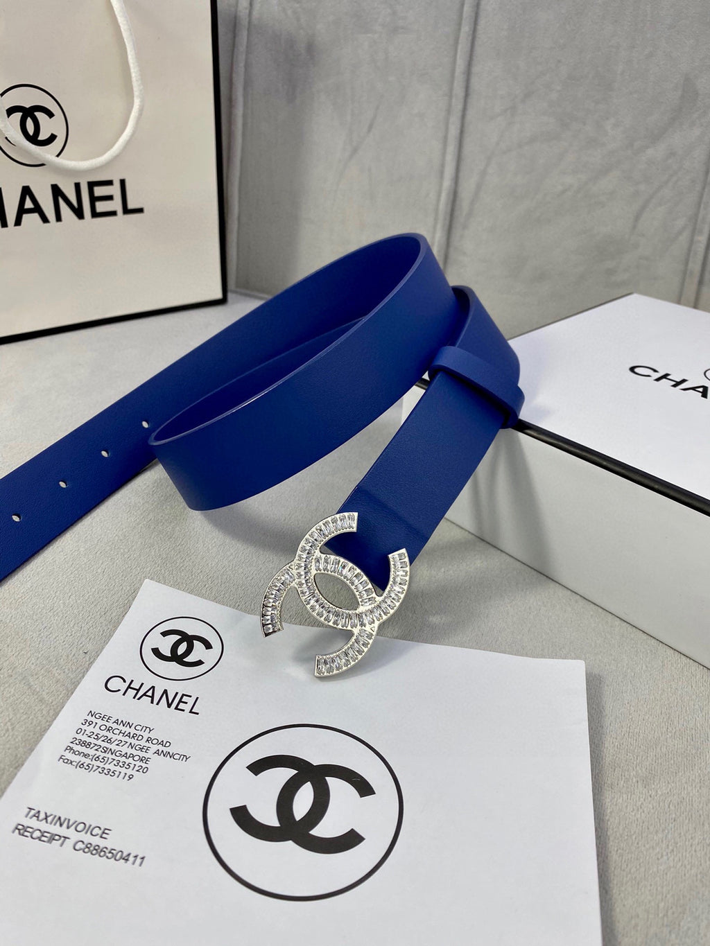 Blue leather belt with rhinestone CC buckle, loop through strap and stud holes