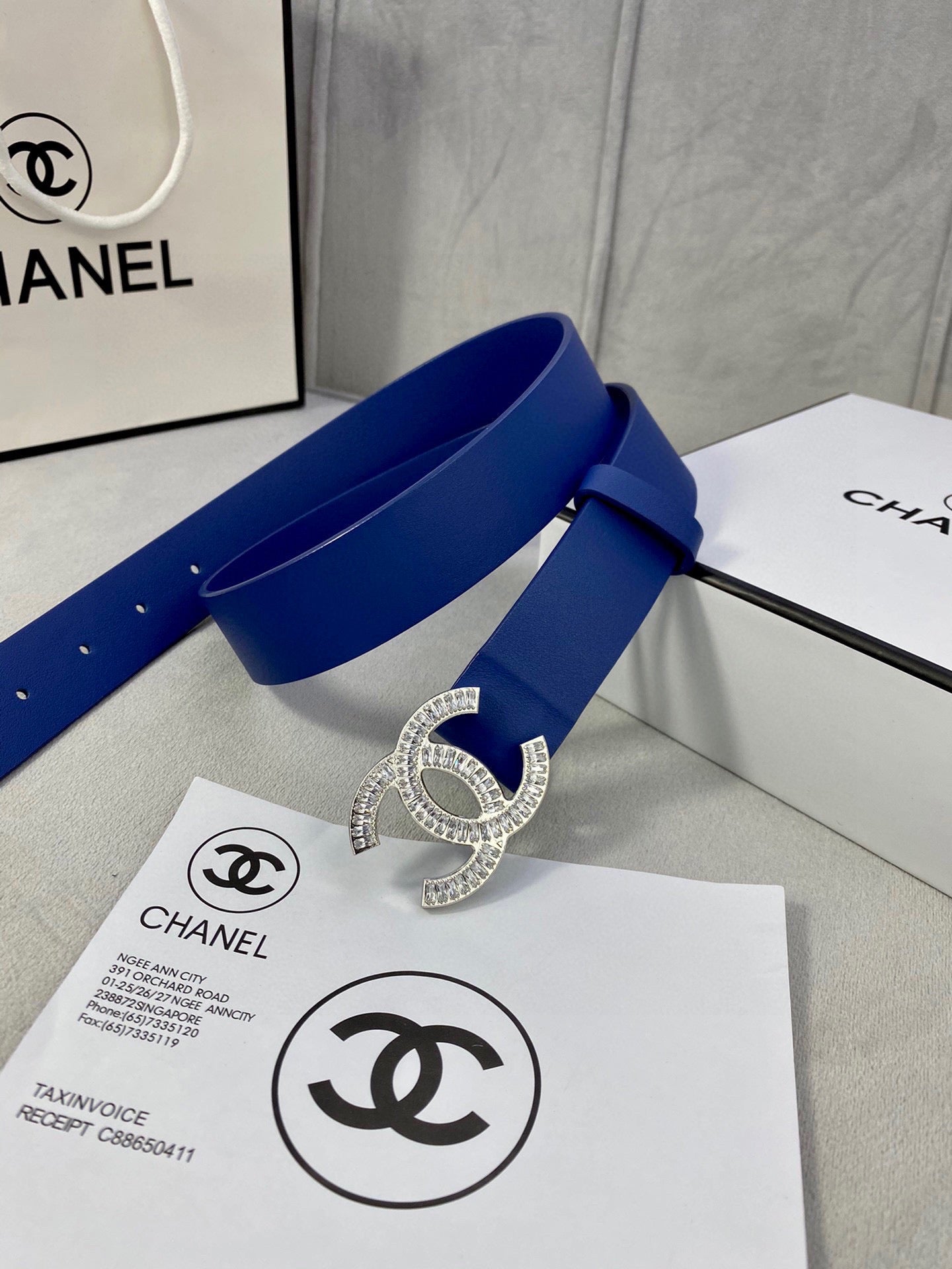 Blue leather belt with rhinestone CC buckle, loop through strap and stud holes
