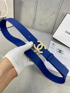 Blue leather belt with gold-tone rhinestone CC buckle, held curved for fit view