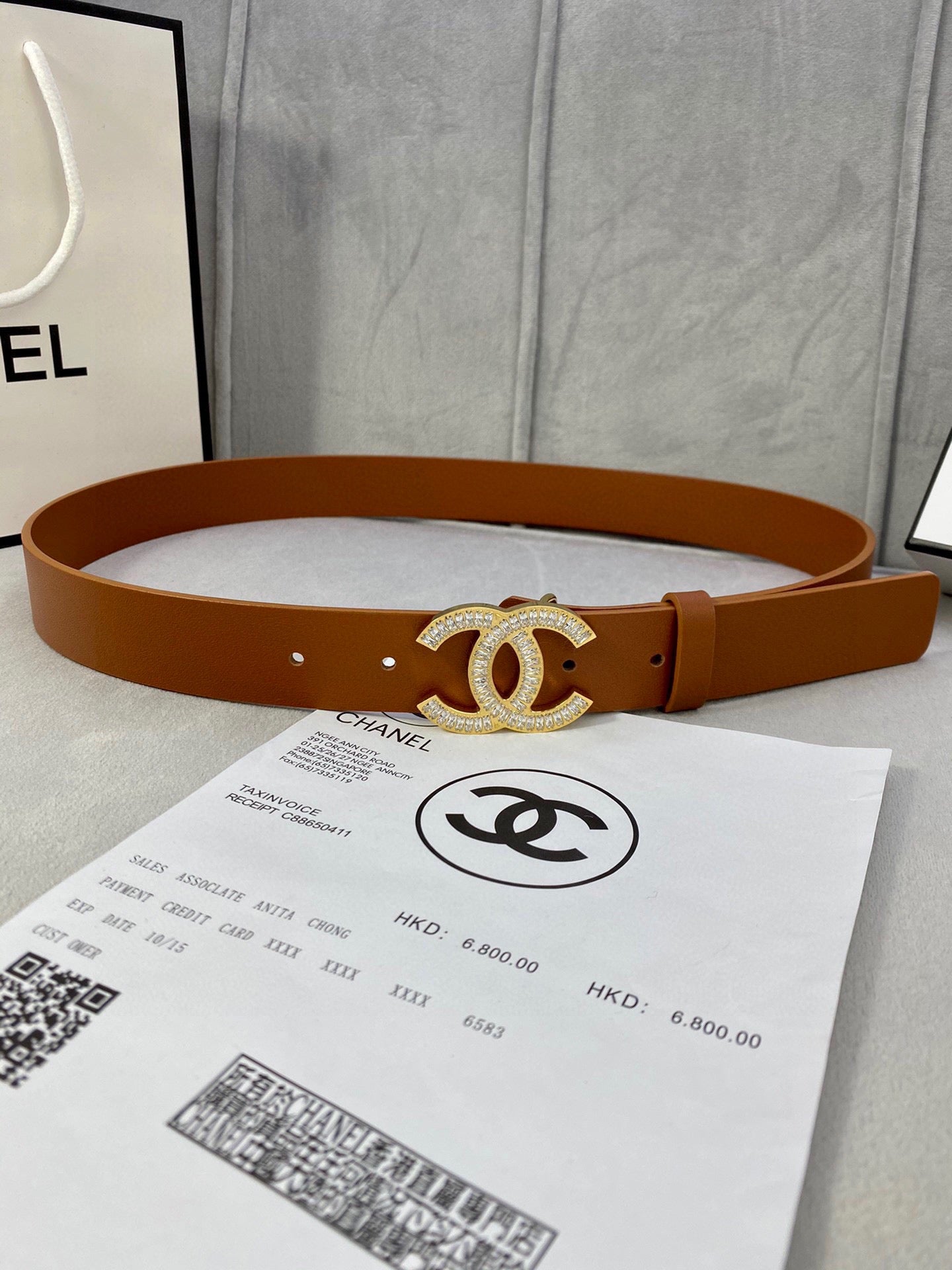 Brown leather Chanel belt with gold-tone rhinestone CC logo buckle and multiple holes