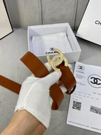 Brown leather Chanel belt with gold-tone rhinestone CC buckle, shown above packaging