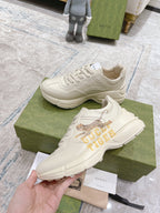 White Gucci unisex sneakers, lace-up with tiger side graphic and molded sole.