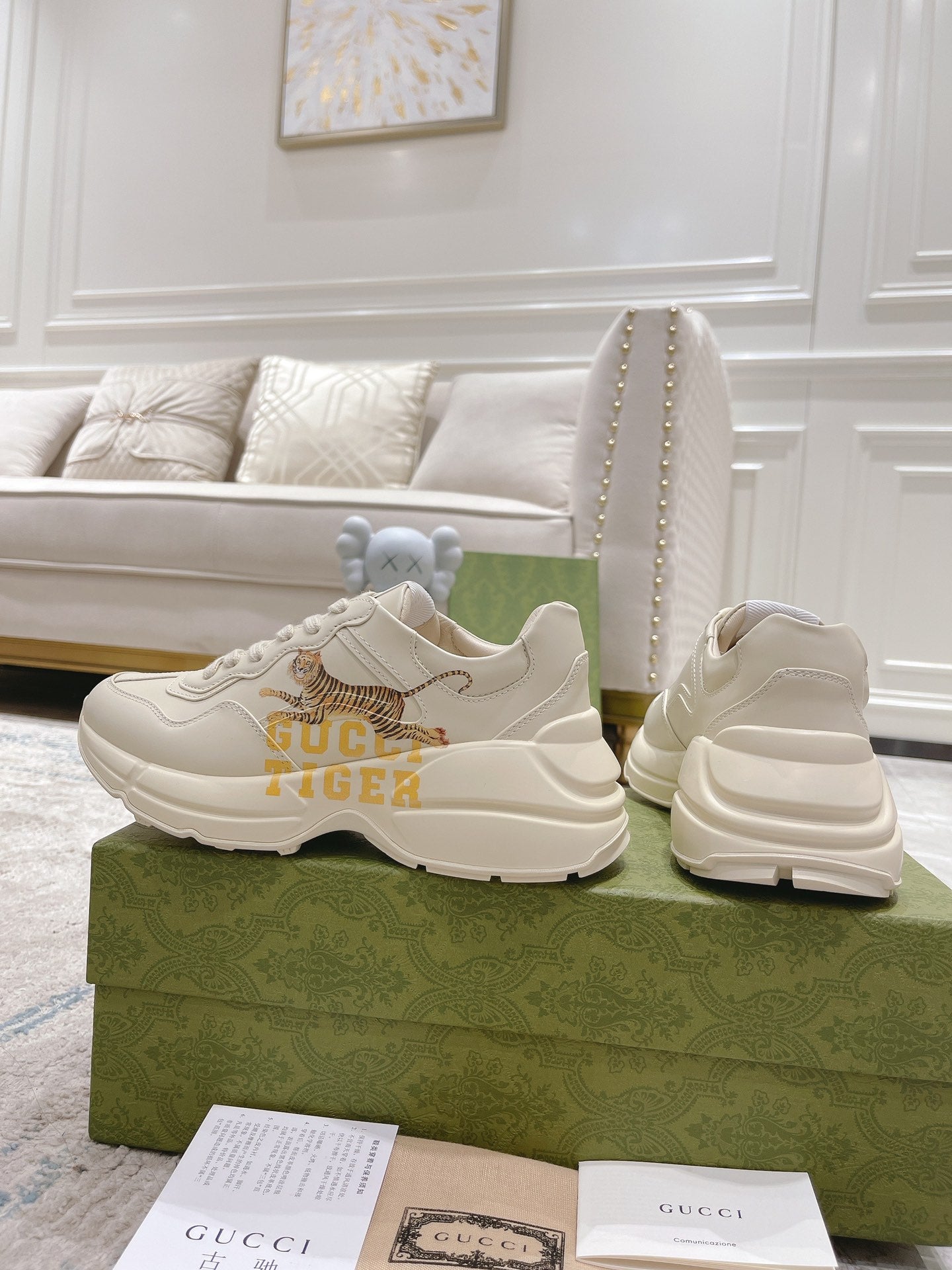 White Gucci unisex sneakers, pair with tiger graphic and chunky heel sole on box.