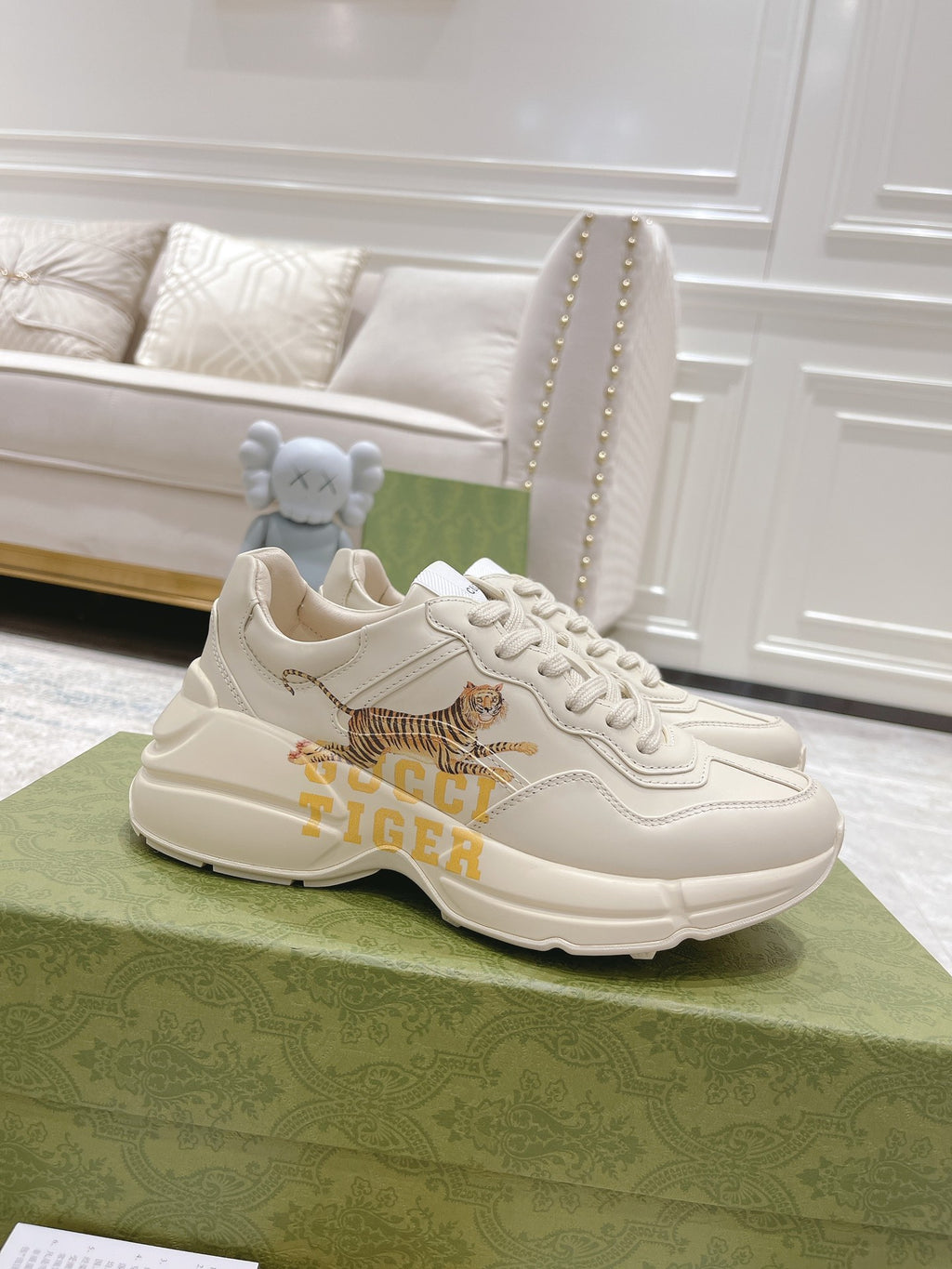 White Gucci unisex sneaker with tiger graphic, lace-up front and chunky sole.