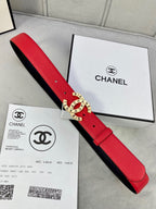 Chanel belt laid flat: red leather strap with gold CHANEL logo buckle and black inner backing.