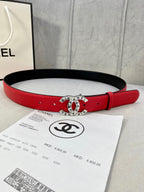 Chanel belt with red leather strap and gold logo buckle on a black underside.