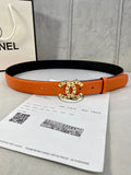 Orange leather belt with black lining and Chanel logo round buckle