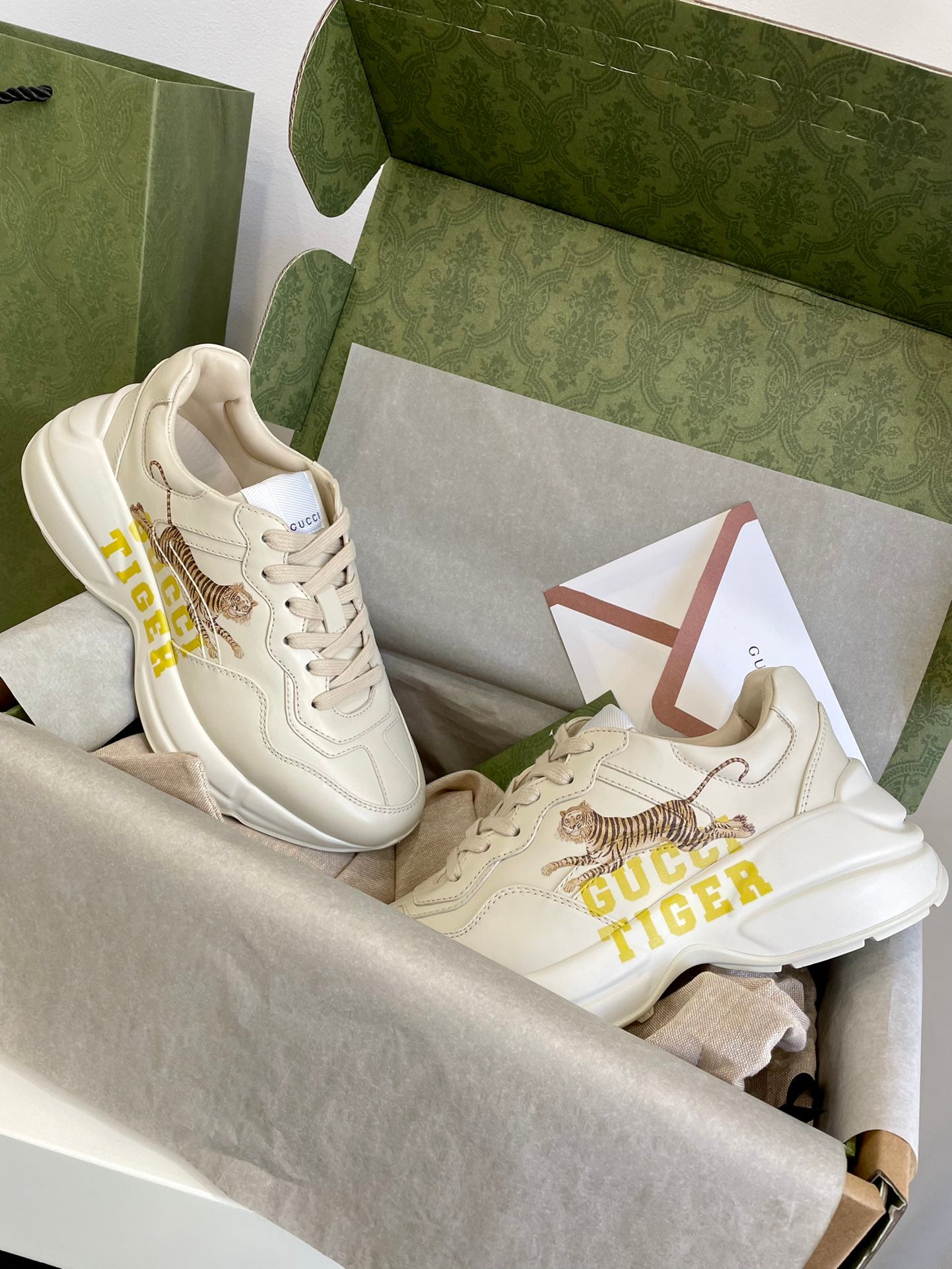 Pair of Gucci unisex sneakers in cream leather with tiger graphic and yellow GUCCI TIGER