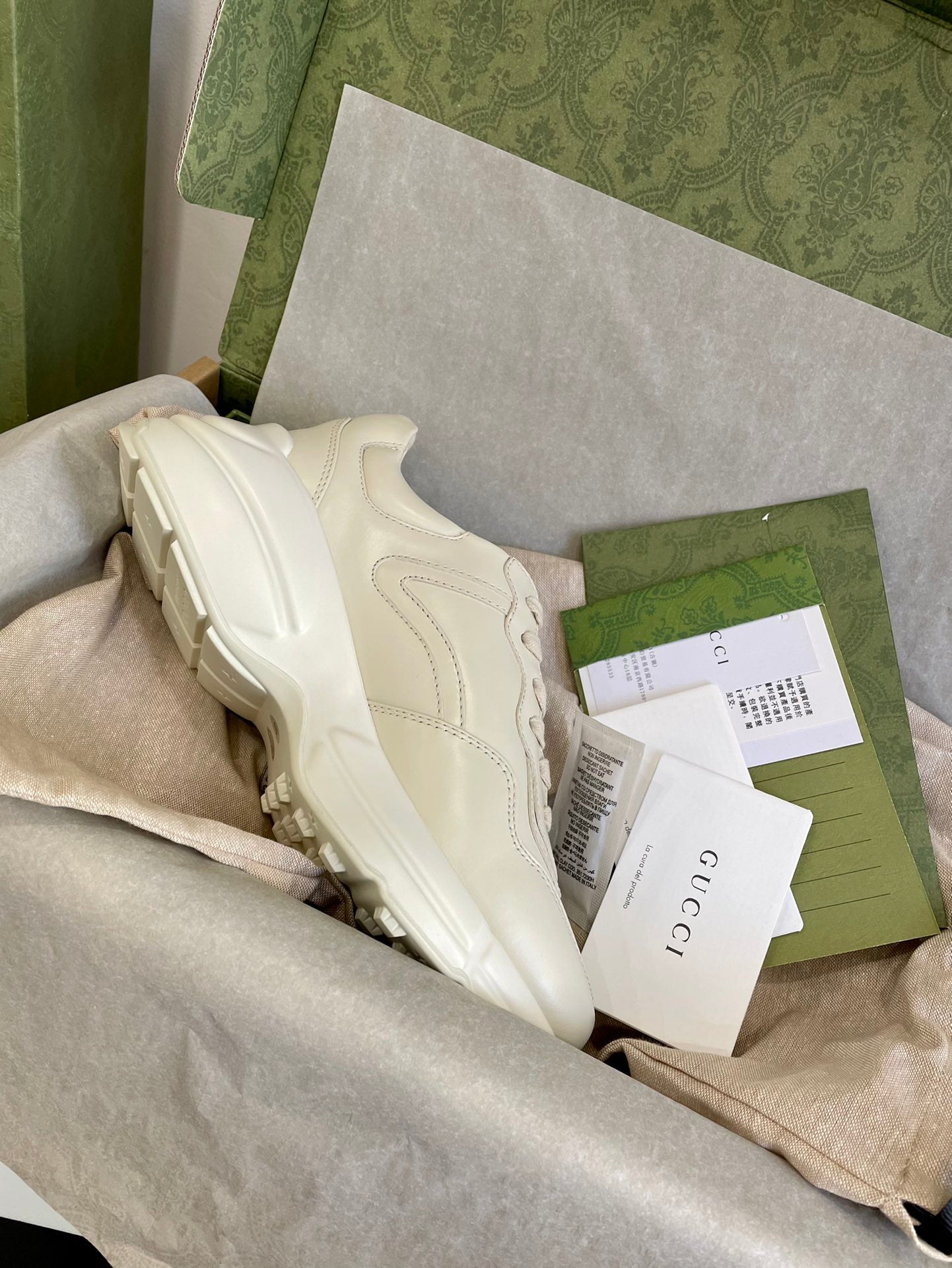 Cream Gucci unisex sneakers, rear view with stitched panels and sculpted rubber sole