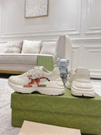 Gucci unisex white luxury sneakers set with lace-up pair and stacked heel profile