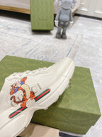 White Gucci unisex sneaker toe and side with colorful cartoon stripe graphic