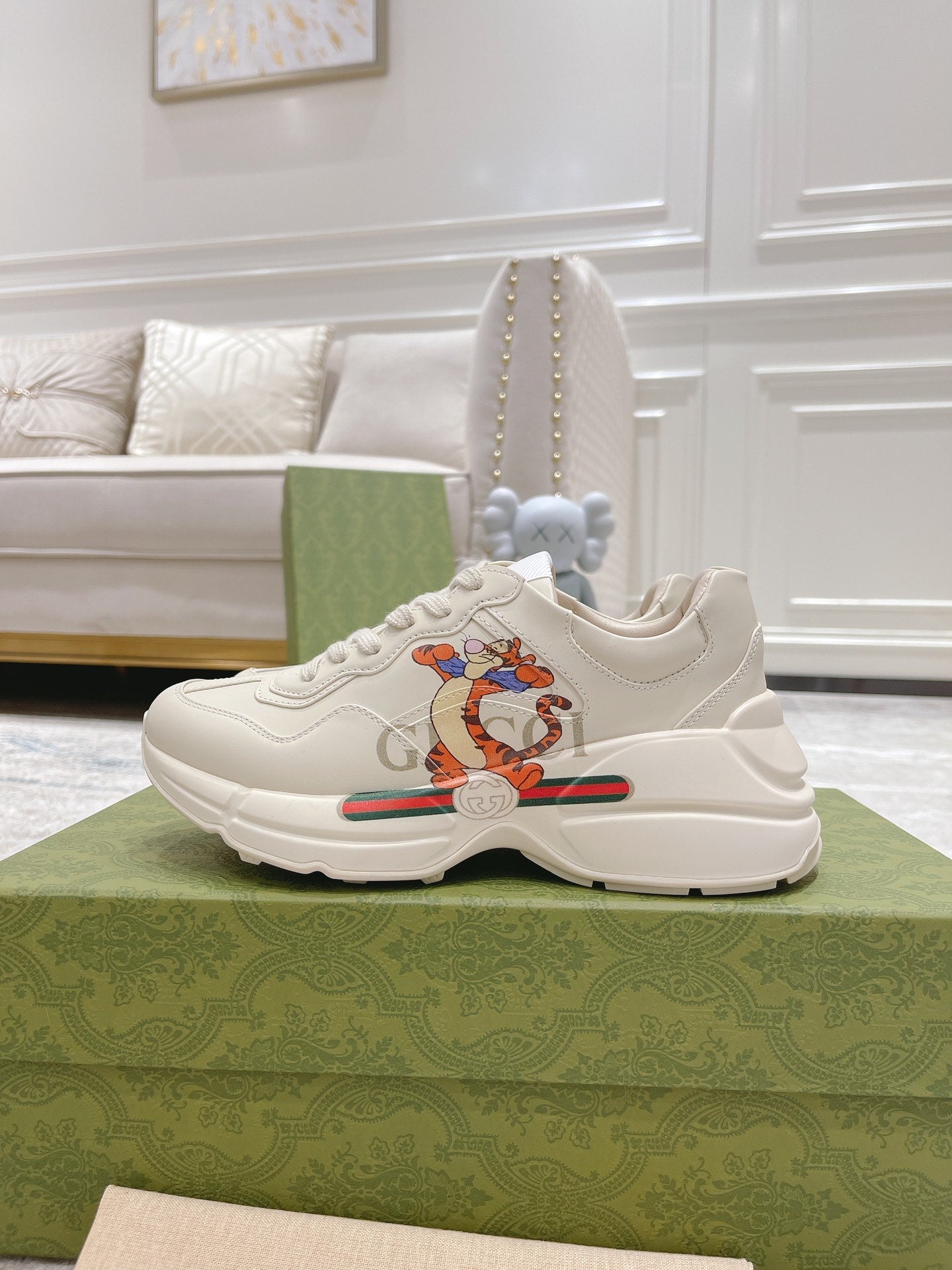 White Gucci unisex sneakers with lace-up front and colorful cartoon emblem