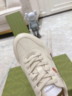 White Gucci unisex sneaker upper close-up with laces and side stitching
