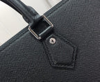Men's Louis Vuitton tote bag close-up of textured leather strap attachment and stitching