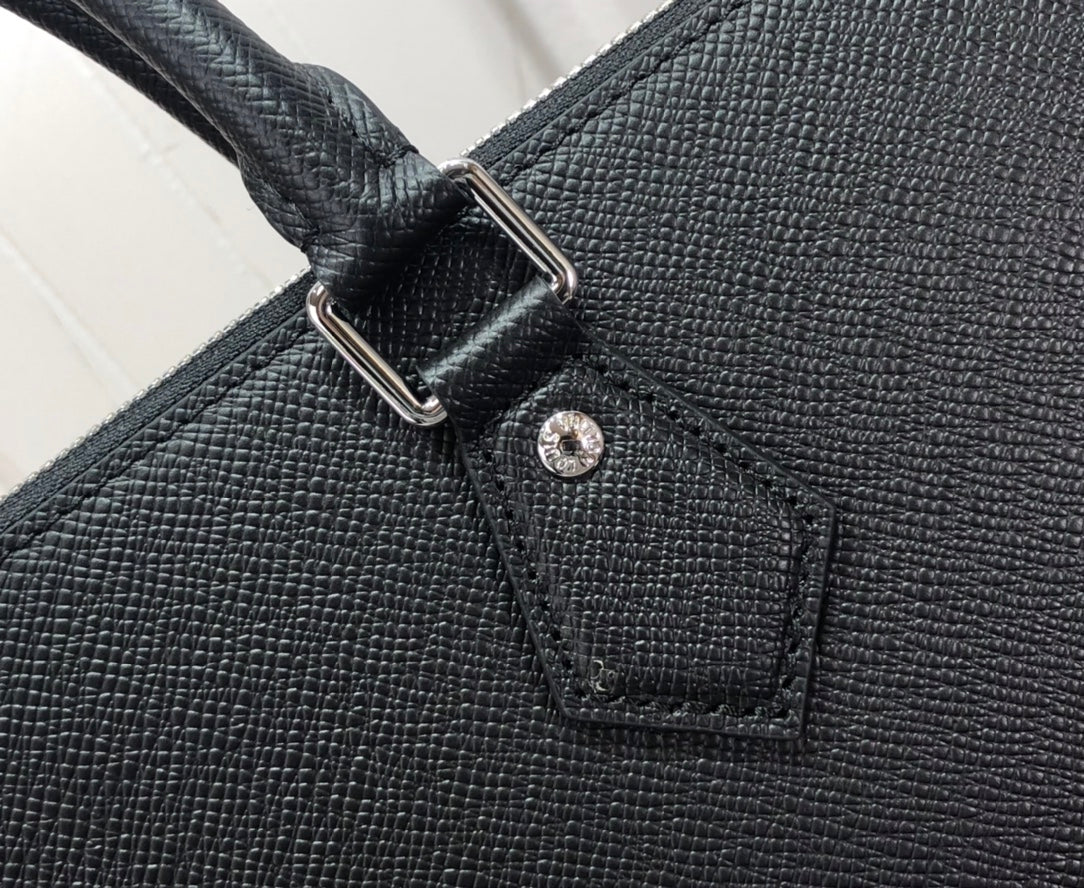 Men's Louis Vuitton tote bag close-up of textured leather strap attachment and stitching