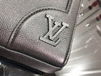 Men's Louis Vuitton tote bag close-up of embossed logo detail on textured leather