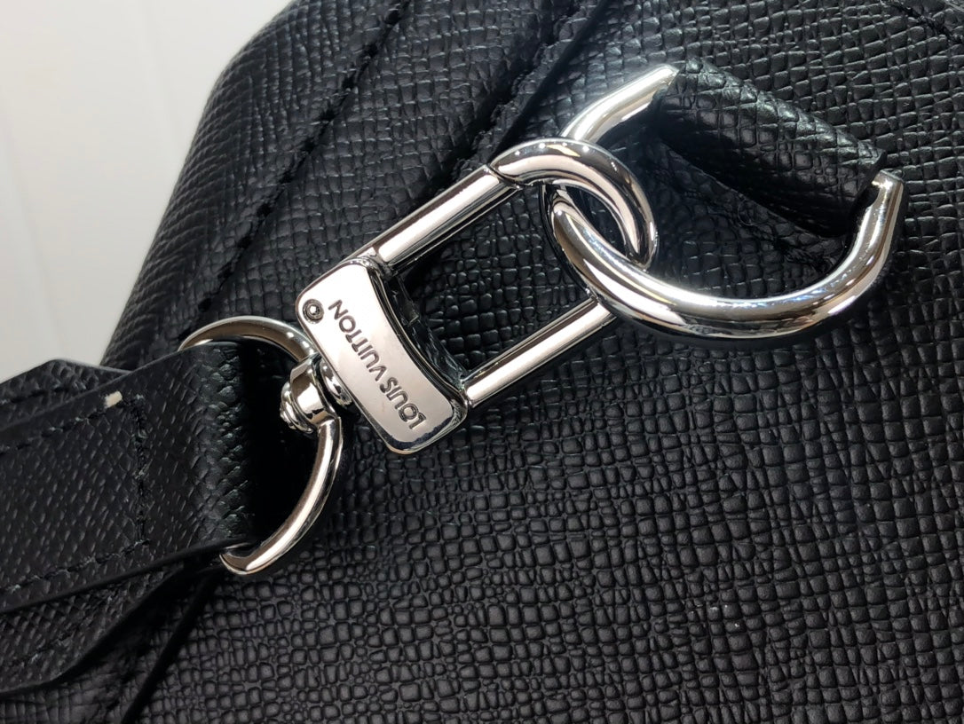 Men's Louis Vuitton tote bag close-up of metal strap hook hardware on textured leather