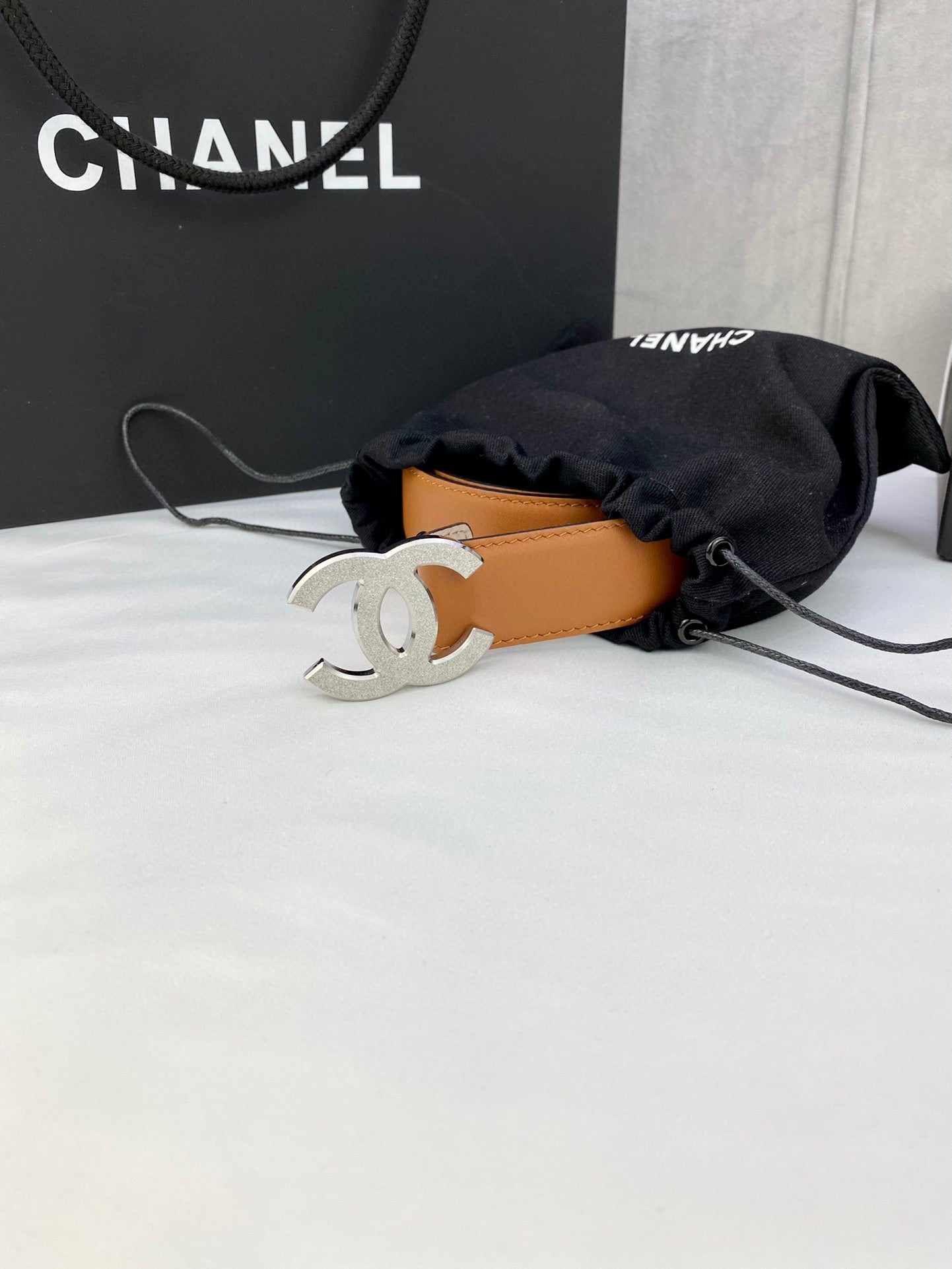 Tan leather Chanel belt with silver-tone CC buckle
