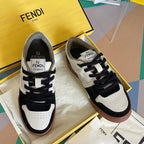 Fendi unisex sneakers with white uppers, black panels, and brown rubber sole