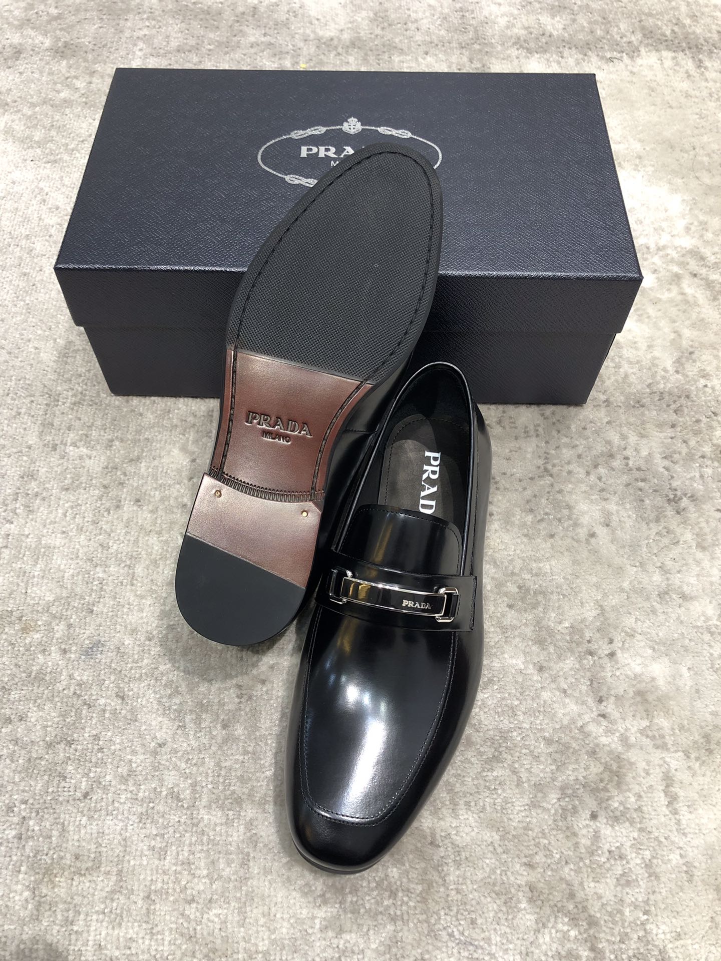 Prada unisex black leather loafer with buckle strap, sole detail