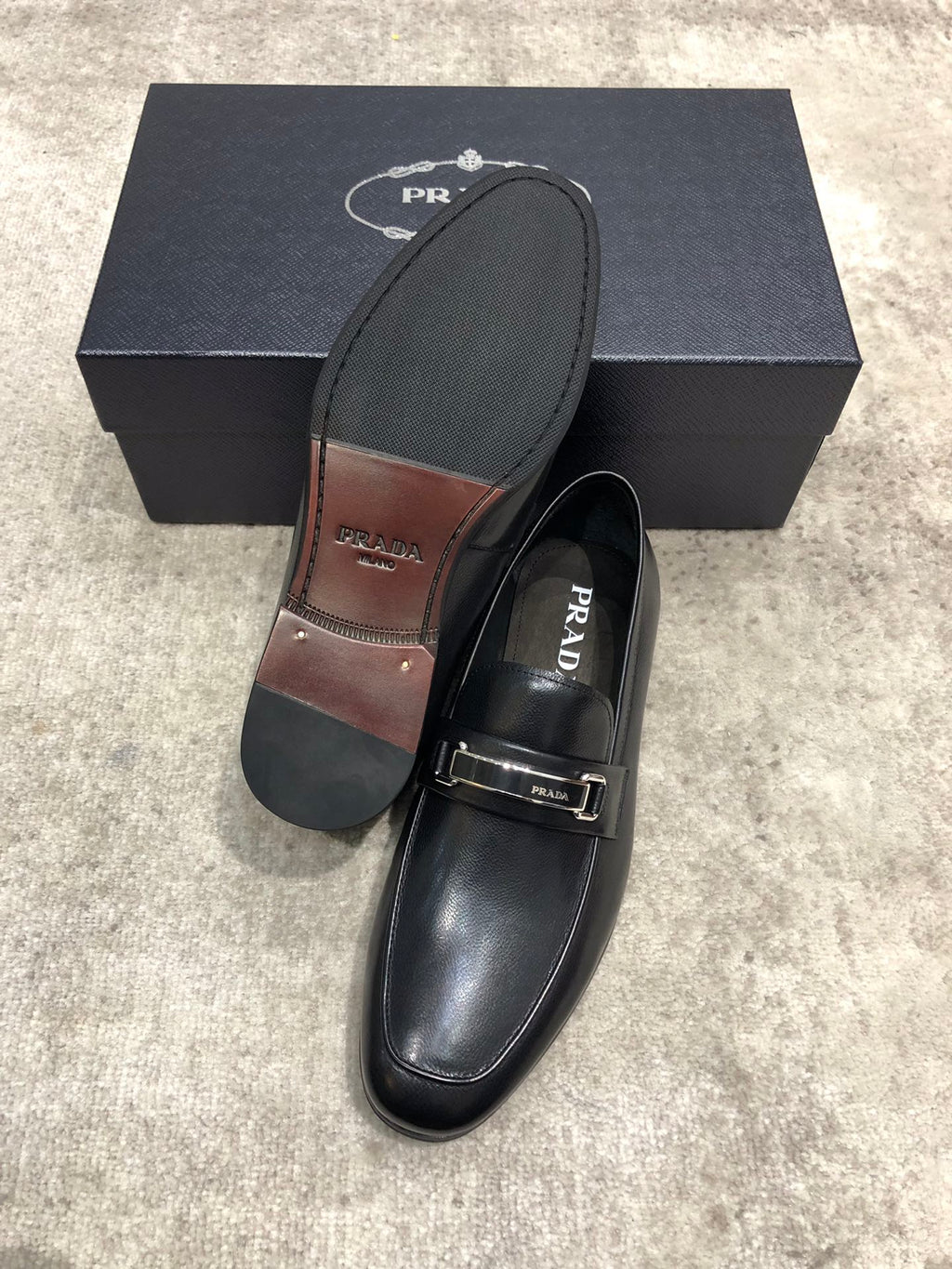 Prada unisex loafers, black leather slip-on; outsole and footbed shown