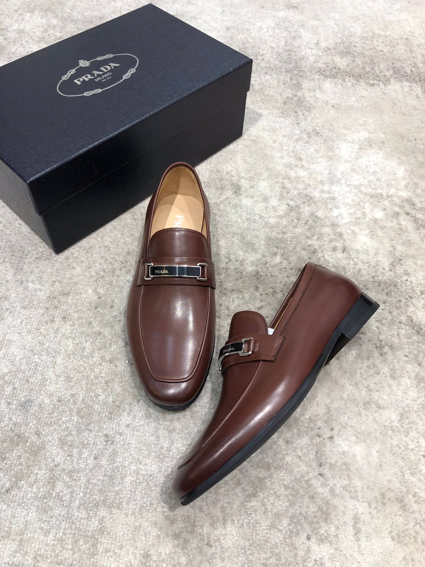 Prada brown leather slip-on loafers with side strap and low heel