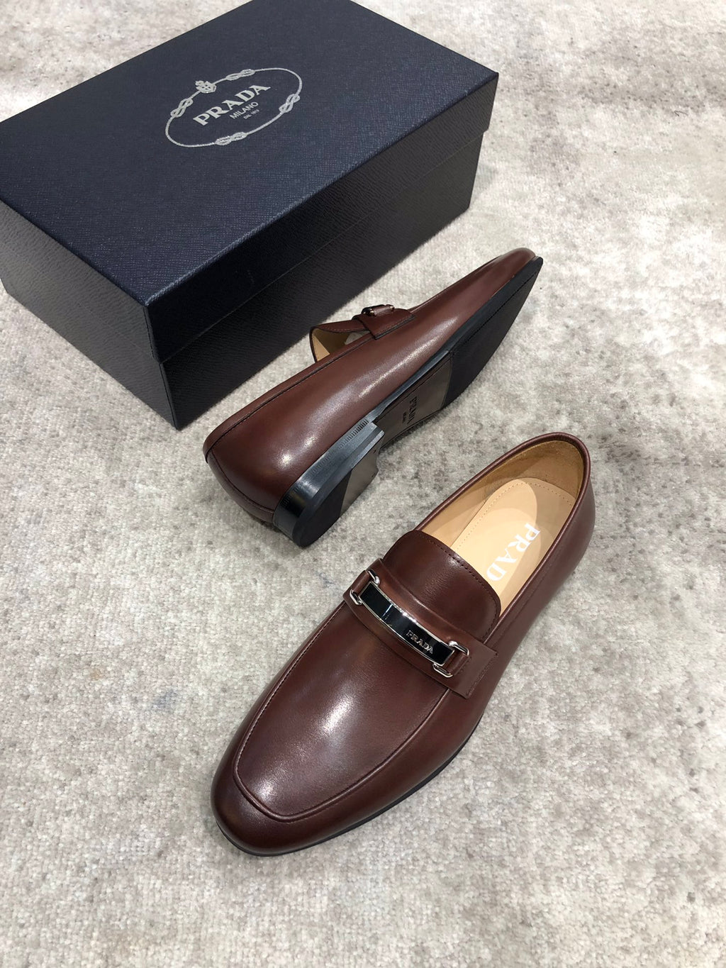 Prada brown leather loafers with buckle strap and flat sole