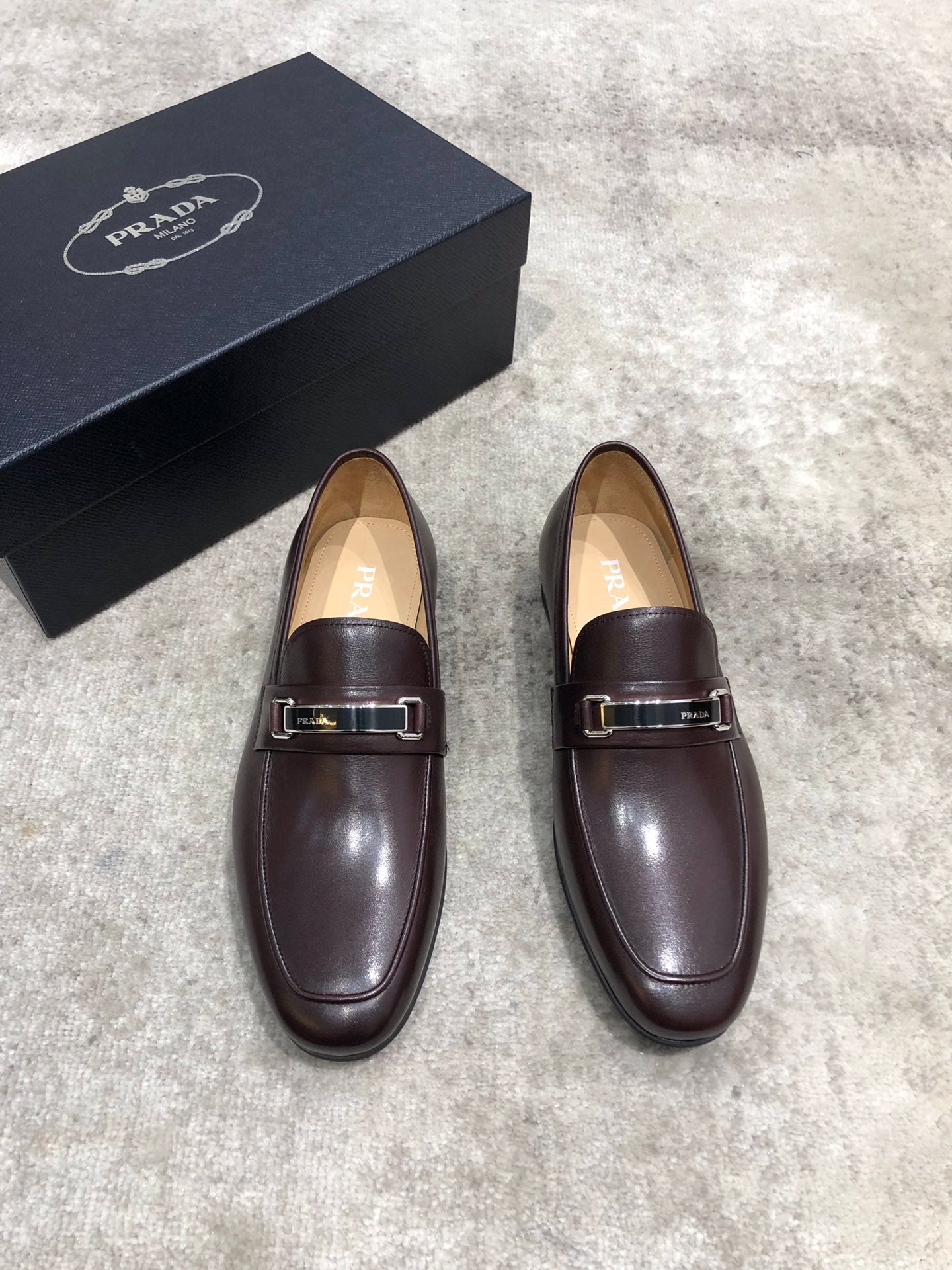 Prada unisex leather loafers, dark brown with metal buckle strap